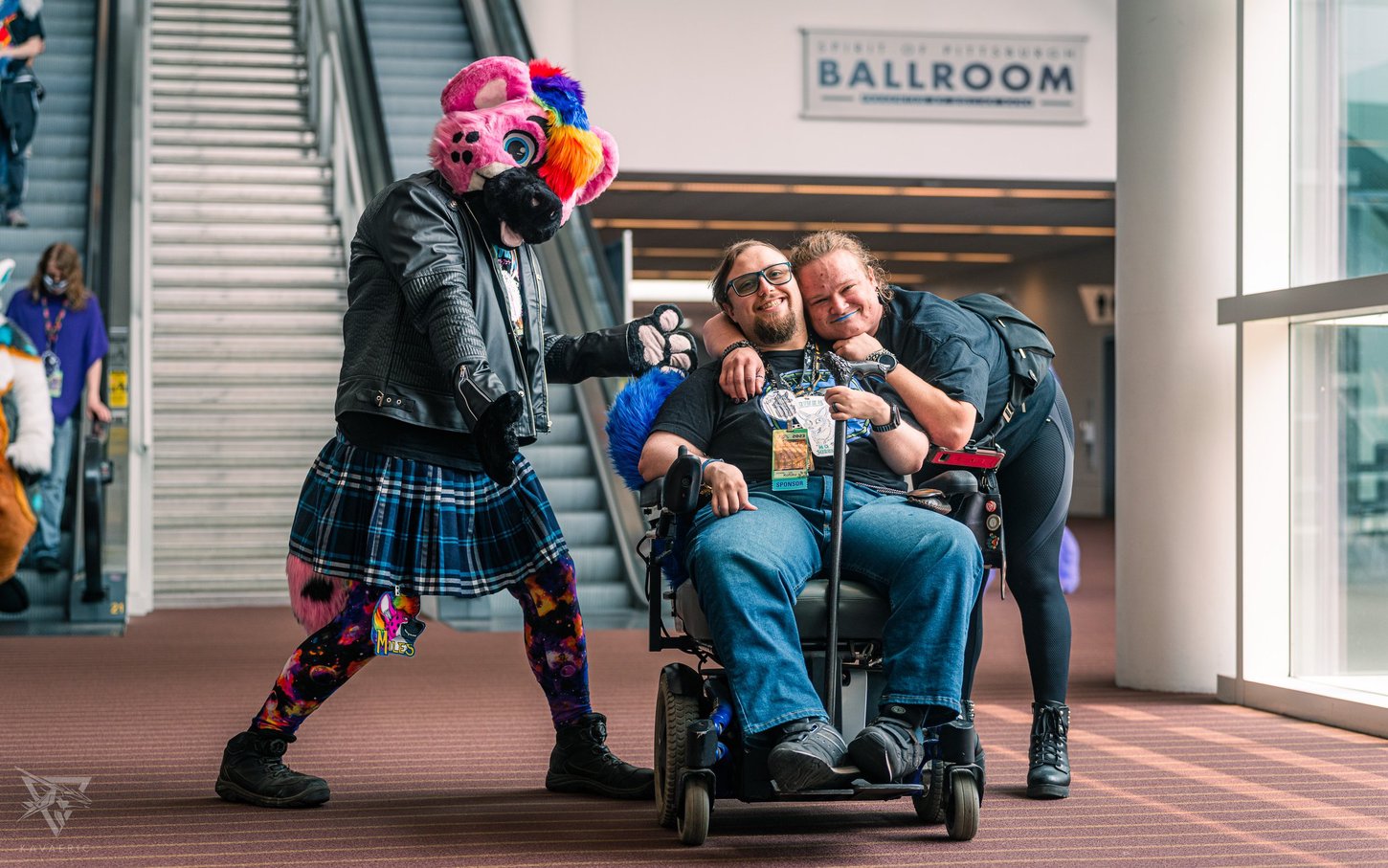 An Anthrocon attendee in a wheelchair enjoying the convention with friends.