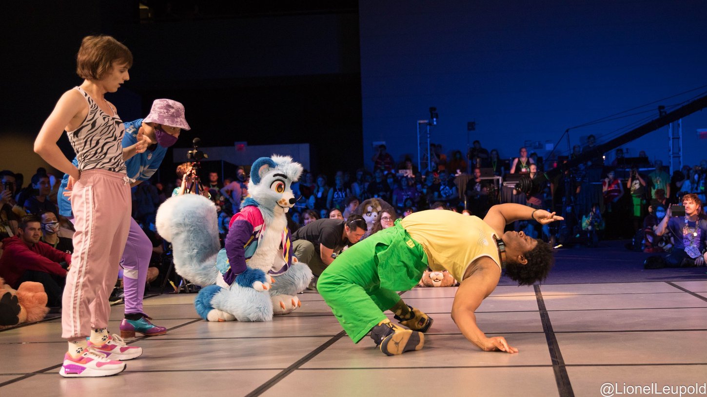 Furries and fursuiters battling each other on the floor during Floor Wars.