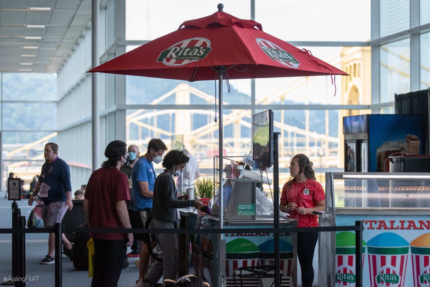 Anthrocon attendees lining up at a food vendor cashier inside the convention center.