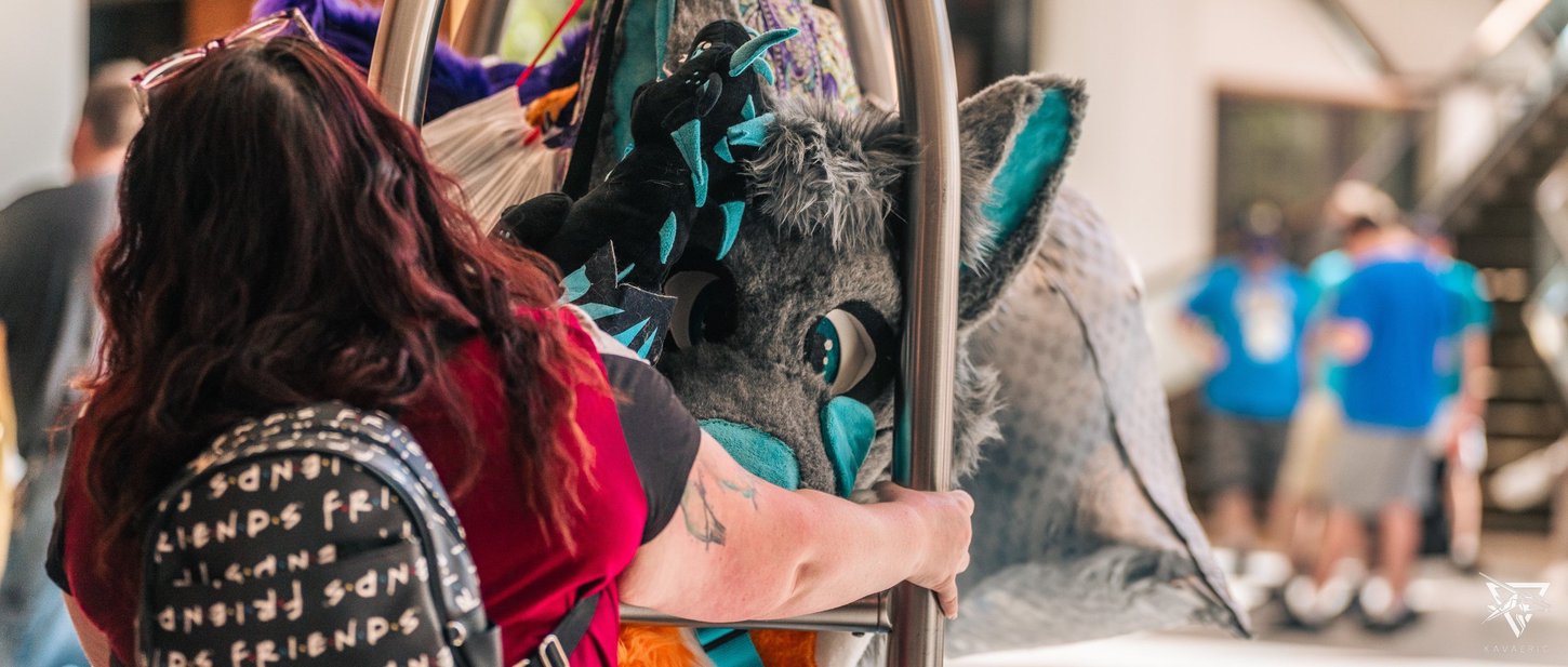 A picture of a fursuit head on a luggage cart.