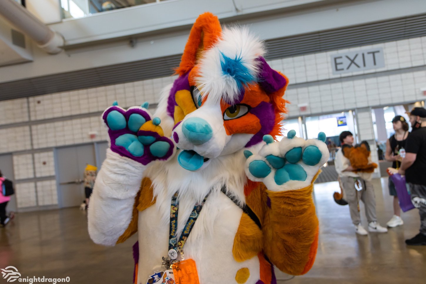 A fursuiter posing for a picture in Anthrocon's Dealers Room.